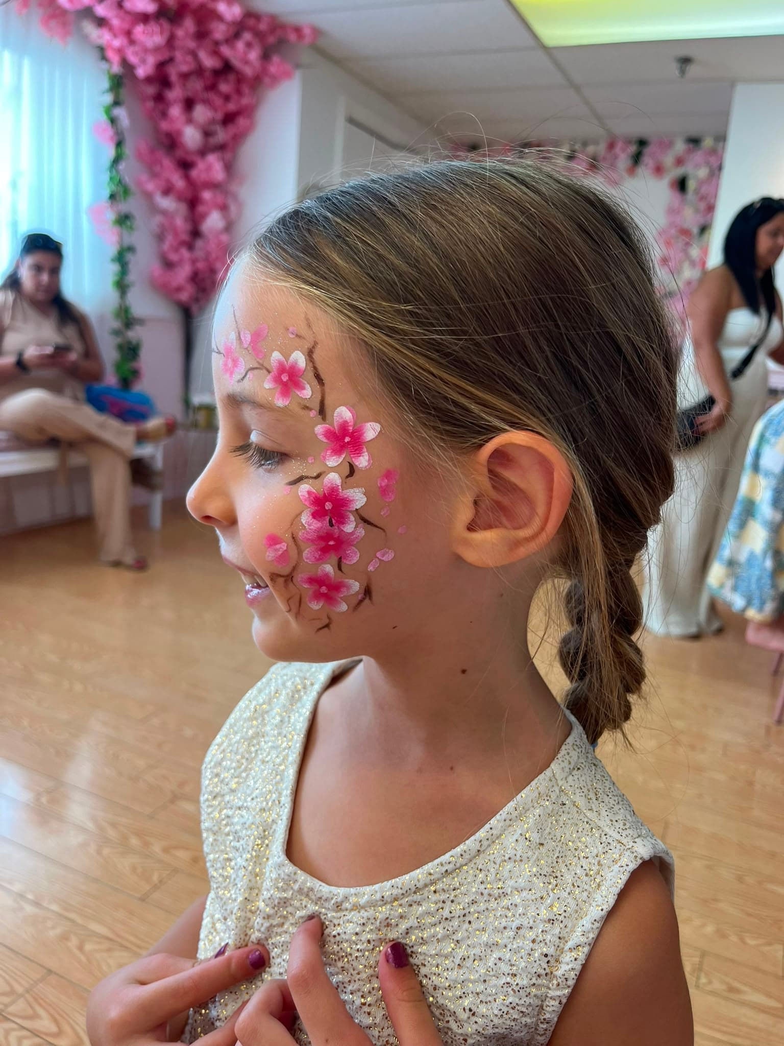 A young guest with floral face painting at Hily's