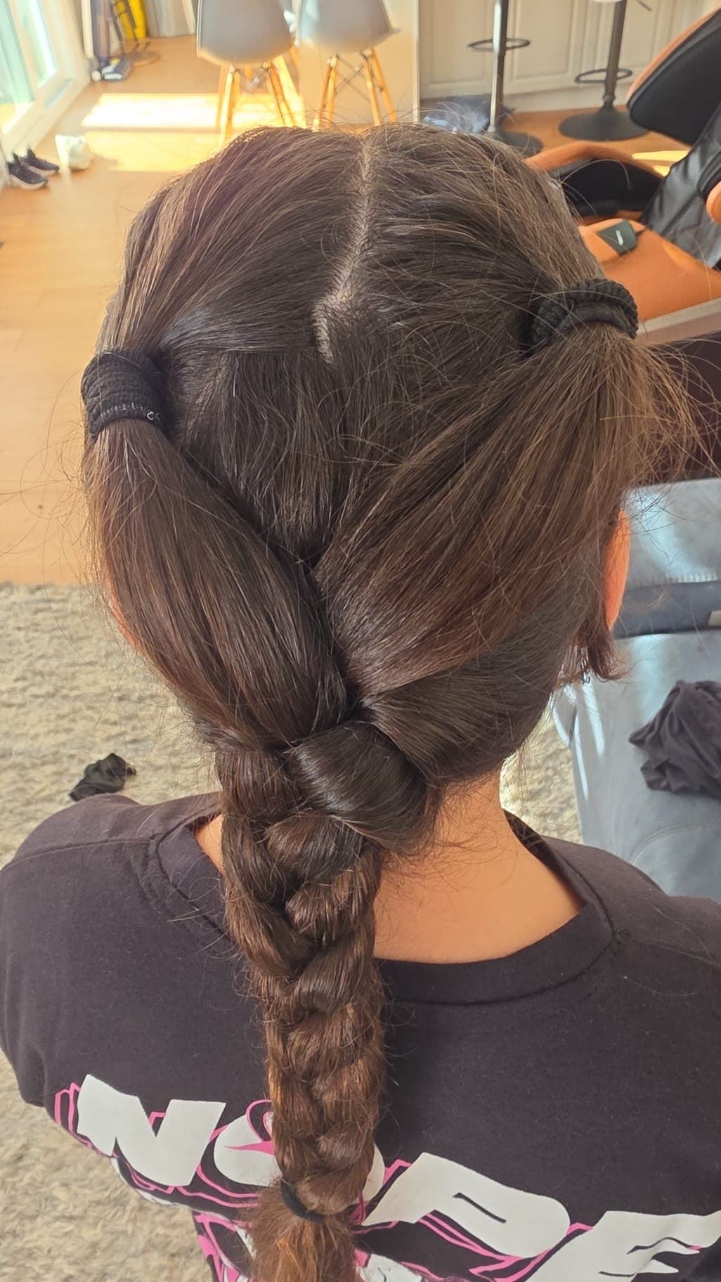 A finished braided hairstyle in the Hily's spa chair
